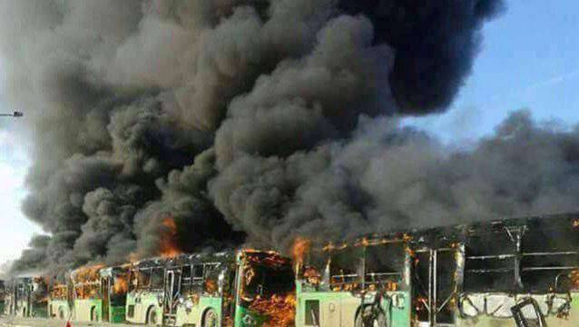 A view shows burning buses while en route to evacuate ill and injured people from the besieged Syrian villages of al-Foua and Kefraya, after they were attacked and burned, in Idlib province