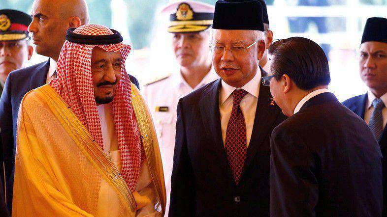 Saudi Arabia's King Salman meets with ministers next to Malaysia's Prime Minister Najib Razak at the Parliament House in Kuala Lumpur