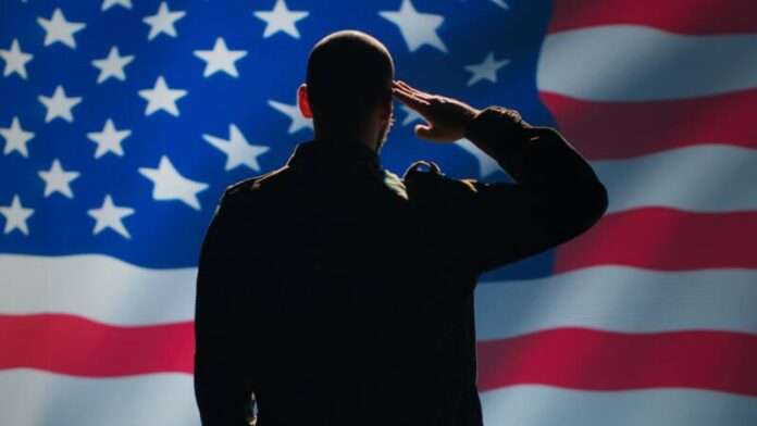 Soldier serving in United States Armed Forces, doing patriotic gesturing